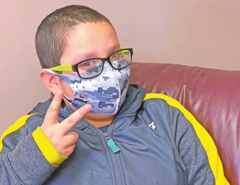 Saxon Flores poses in his colorful gray digital camouflage face mask. Send in your best photo of your most colorful or creative face mask for a chance to win a prize sponsored by West Okie Boutique. BEACON PHOTO