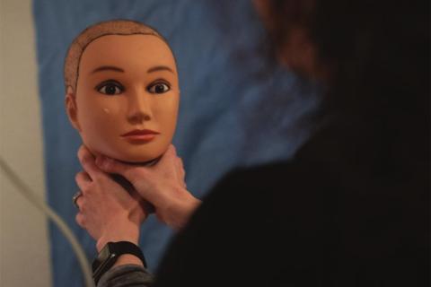 Jessica Collett, nurse examiner at the Women’s Resource Center in Norman, demonstrates the dangers of strangulation on a mannequin head at the Rape Crisis Center. Nurses offer the mannequins to victims when they are asked to recount details of their attack. Whitney Bryen/Oklahoma Watch