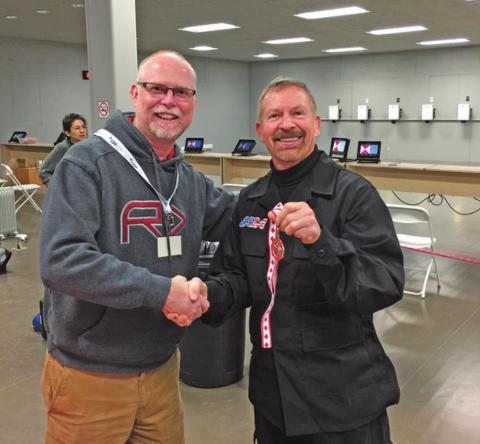 Richard Horne, Vice President of Canadian Gun Gran Prix, presents a medal to Ken Kliewer on April 18, 2018 in Cookstown, Ontario, Canada. Kliewer won Marksman Division in his first international Air Pistol competition.