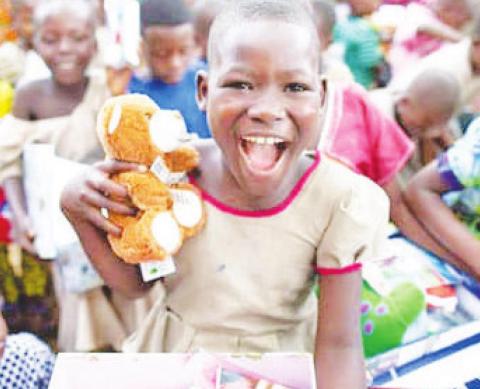 A happy recipient receives a shoebox gift from 'Operation Christmas Child'
