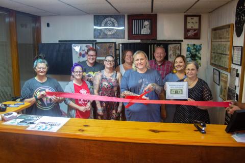 Owner of Wookies Tattoo and Body Piercing Rachel Jones gathers around with friends and family as they take part in the ribbon cutting ceremony put on by the Chamber of Commerce.