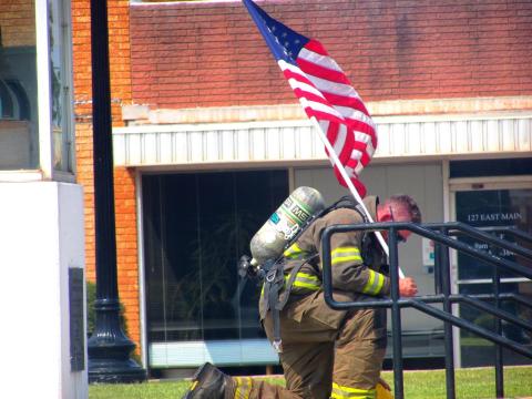Tyler Arrington kneels on the courthouse lawn. 