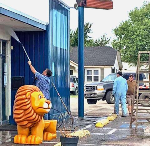 Volunteers begin to powerwash Canute City Hall in preperation to be painted. CONTRIBUTED PHOTO