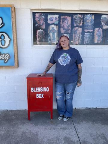 Rachel Jones standing by her outdoor 'Blessings Box'