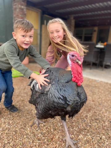 Whitten and Waverly Schneberger with their pet turkey, Tommy. 
