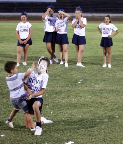 Hunter Larsen smears a plate full of whipped cream in his sister Riley Larsen's face