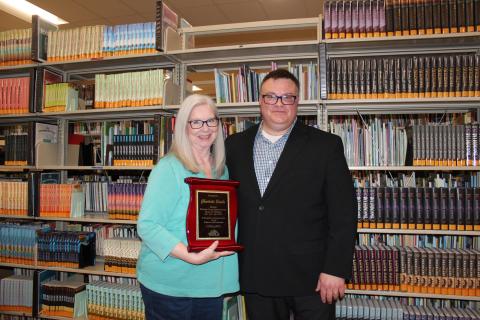 Western Plains Library System Executive Director Tim Miller presents Charlotte Betche with a plaque in recognition of her time on the library Board