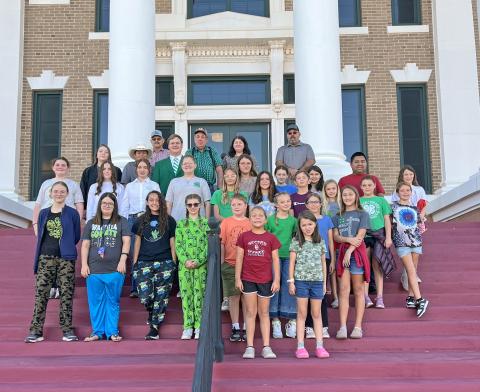 Washita County 4-H members met with the County Commissioners to witness the signing of the official National 4-H Week Proclamation
