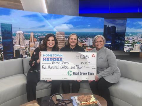 News 9's Lacey Lowry and Quail Creek Bank's Erin Batey present Rachel Jones with the Hometown Hero Award