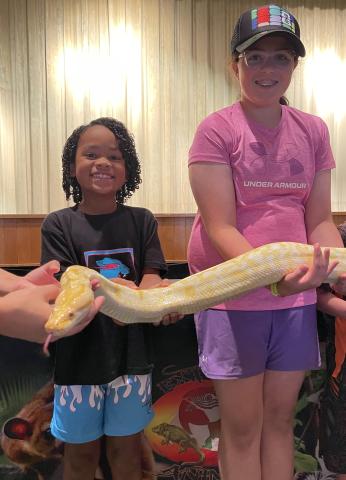Imre Jordan and Ellie Holman with Banana The Burmese Python