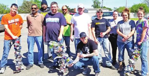 TOP: Some of the program participants gather for a group photo after completing their portion of the highway section. Aluminum cans are one of the main types of litter that fill the ditches alongside the highways. PHOTOS BY SARAH MEARS-IVY