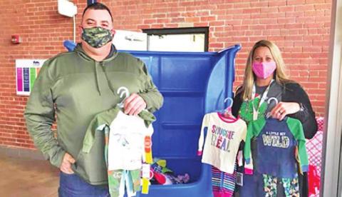 Travis and Chanda Powers show some of the donations they have received for the pajama drive. CONTRIBUTED PHOTO