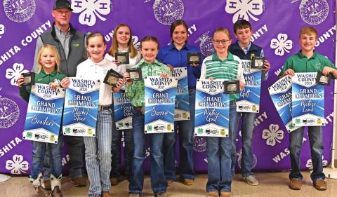 Washita County Junior Livestock Show Grand Champion Exhibitors displaying their banners from the Fair Board and the trophy buckles from Western Equipment. L-R back row: Gary Lynn Randall-Western Equipment, Aubrey Sturgeon, Madison Church, Luke Rozell and Clay Randall. L-R Front Row: Cassi Ray, Bentlee Lester, Sayde Allen and Kinley Pruett. Not Pictured: Colt Randall. CONTRIBUTED PHOTOS