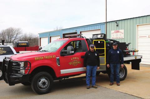 Corn firefighters Bart Gossen, left, and Sean Estes show off the department’s new brush truck. Bob Henline | The Cordell Beacon