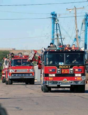Cordell students arrive atop area fire engines. Bob Henline | The Cordell Beacon