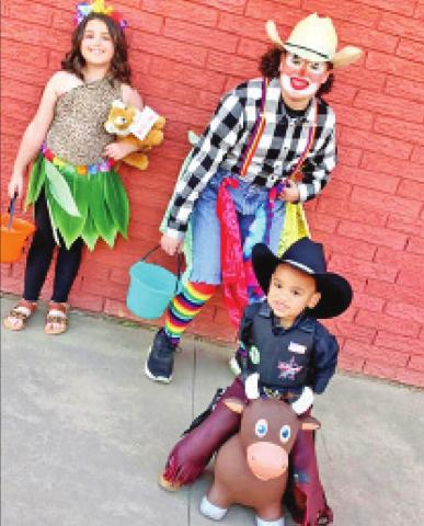 Top left: Ellison Holman as Katy Perry from Roar, Emma Holman as a rodeo clown, and Imre Jordan as a bullrider have fun at the Cordell Chamber of Commerce’s annual event, Spook the Square. See page 14 for more photos.