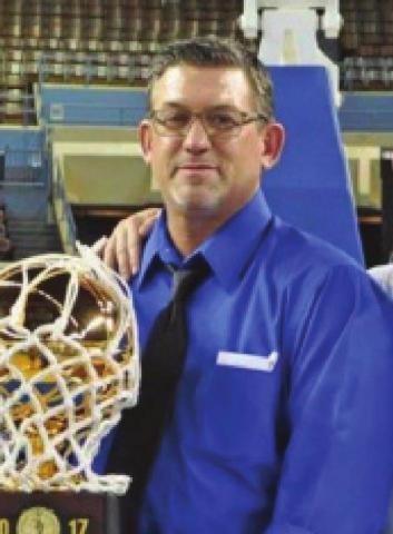 Cordell native son Scott Hines is shown with one of the trophies won by his State Championship basketball teams