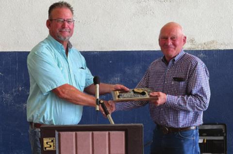 ABOVE: Kevin Nightengale (left) hands Jack Sawatzky (right) a plaque during the 103rd Annual Meeting of the Farmers Cooperative Exchange of Bessie-Cordell-Burns Flat. Sawatzky was recognized for his 32 years of service for the Farmers Cooperative board. CONTRIBUTED PHOTO