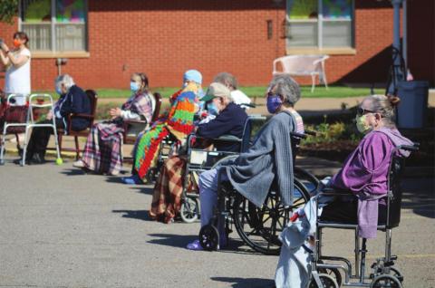 Cordell Christian Home residents gather outside the home to watch a Memorial Day concert. Bob Henline | The Cordell Beacon