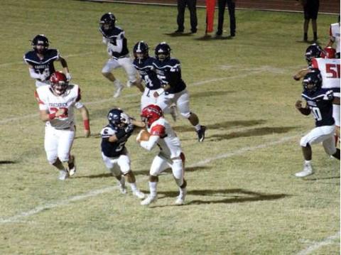 Blaine Larsen cuts off the Frederick running back’s move to the outside while other Blue Devil defenders converge on the play. Bob Henline } The Cordell Beacon