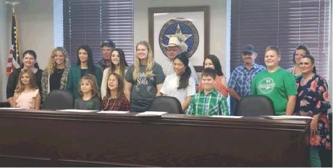 The Washita County Board of Commissioners with local 4-H students after signing the 2019 4-H Week Proclamation. Front, from left: Francesca Bloomer, Kali Bloomer, Vanessa DeRoin, Braxton Barnett. Back: Kristen Dowell, Makia Maxey, Jordan Mason, Leo Goeringer, Logan Davis, Kyla Bloomer, Steve Tompkins, Marcie Diggs, Gabby Espinosa, Bart Gossen, Brance Barnett, Dana Church (Washita Co. 4-H Extension Educator), Larissa Mason (BF-DC Senior Leader). Bob Henline | The Cordell Beacon