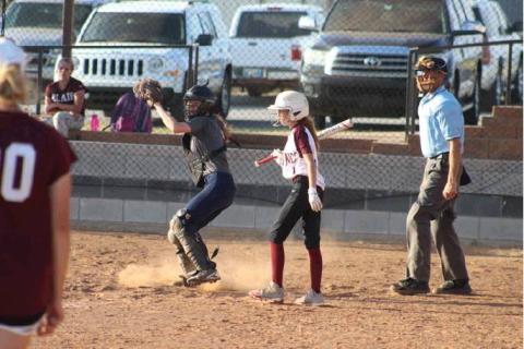 Paige Canterberry hauls in a high pitch and checks the runner at third base against Blair. Bob Henline | The Cordell Beacon.