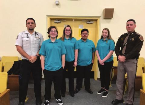 Jeremy Poole (Sinor EMS), left, with WTC Biomedical students Marquez Borjas, Cassidy Blanchard, Bryant Franco, and Kim Arney, along with OHP Trooper Michael Ekchardt, presented a texting and driving assembly at Cordell High School. Photo courtesy of Sarah Hirschman.