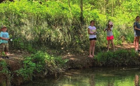 Hunter, Kanin, Maci and Boston catching sunfish in a creek in Murray County. Photo courtesy of OKDWC.